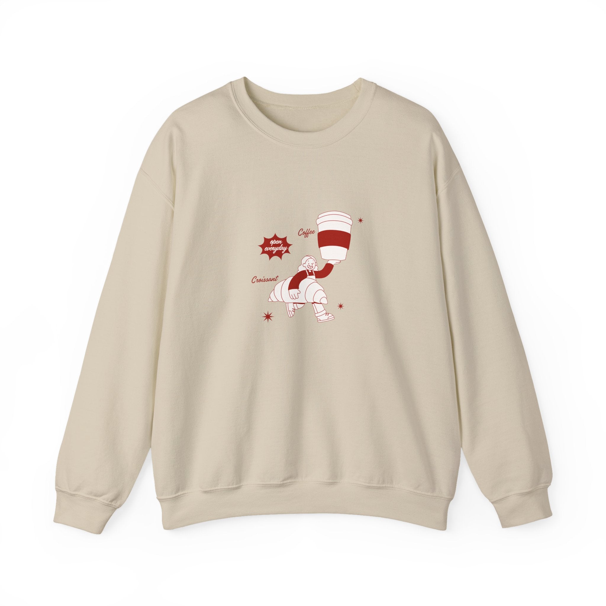 Woman wearing cozy coffee and croissant graphic sand sweatshirt