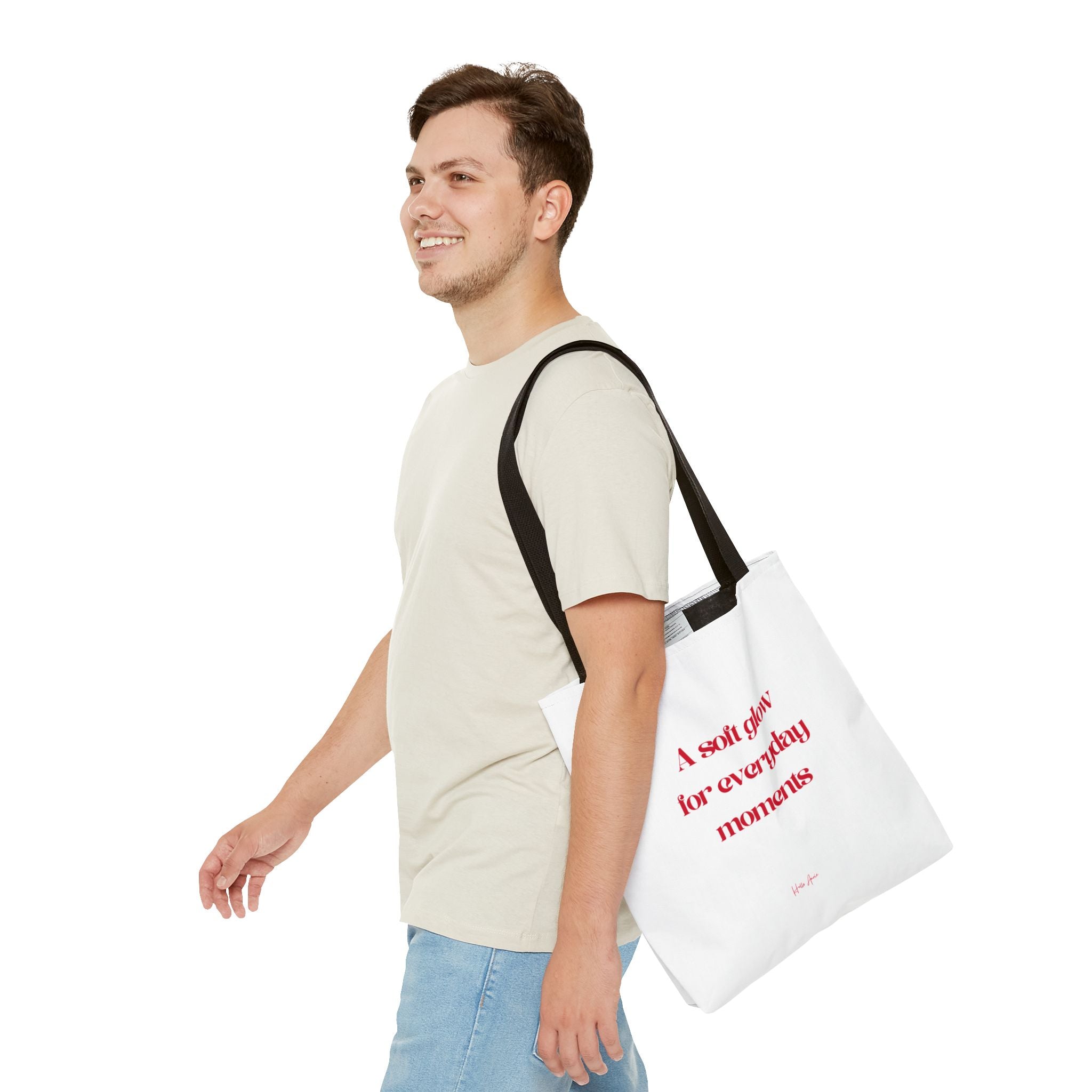Man carrying a white tote bag with red text on a white background